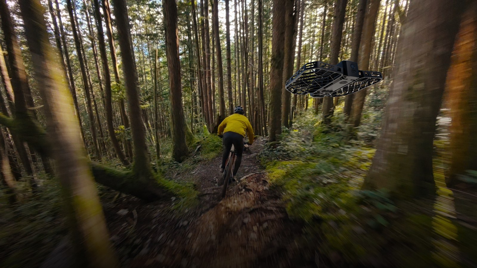 HOVERAir X1 PRO caged drone flying low over a forest trail while filming a mountain biker in a yellow jacket