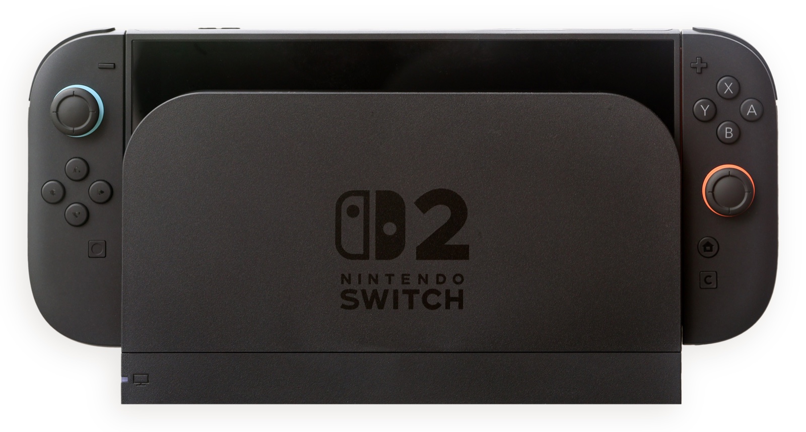 Nintendo Switch 2 console sitting in its dock with black Joy-Con 2 controllers attached, blue and orange rings around the analog sticks