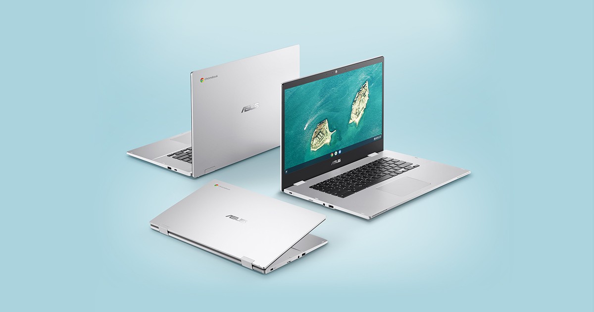 Three silver Asus Chromebooks arranged on a light blue background, one open showing an aerial island wallpaper