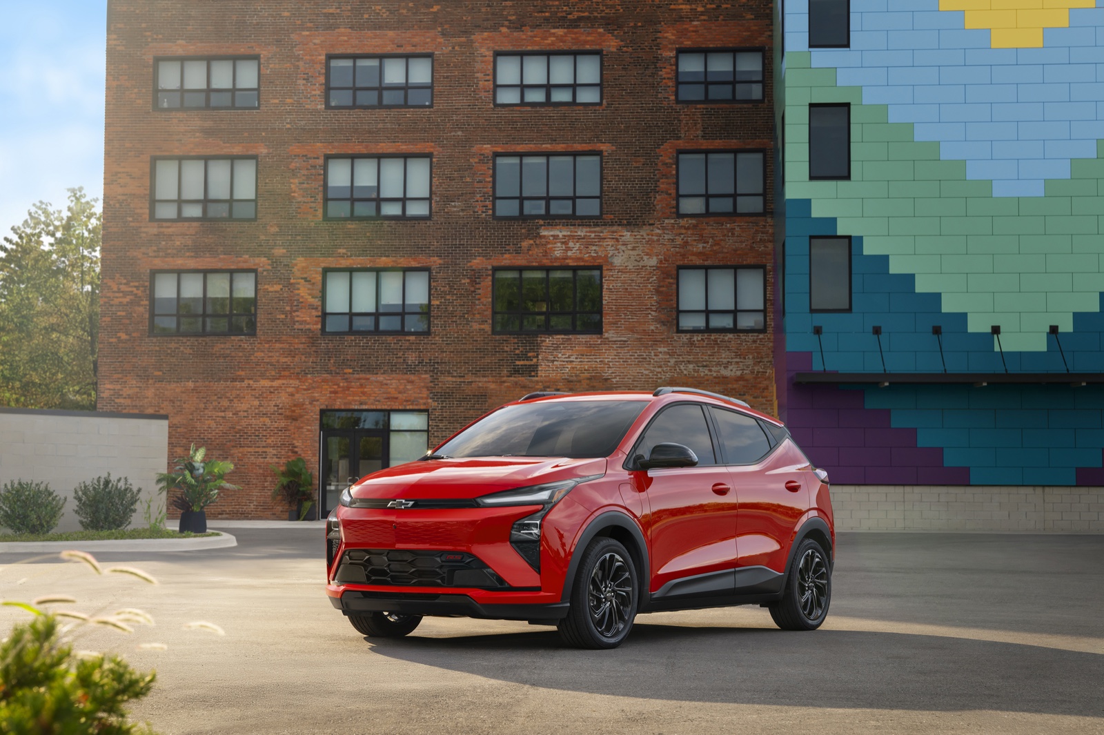 Orange 2027 Chevrolet Bolt RS, front three-quarter view