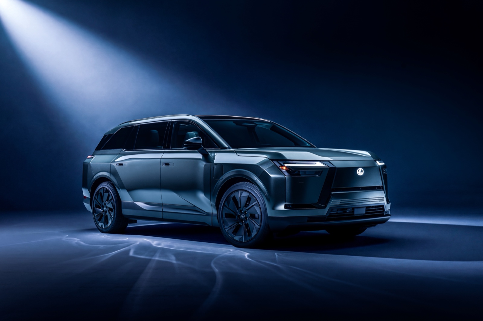 Silver 2027 Lexus TZ three-row electric SUV, front three-quarter studio view