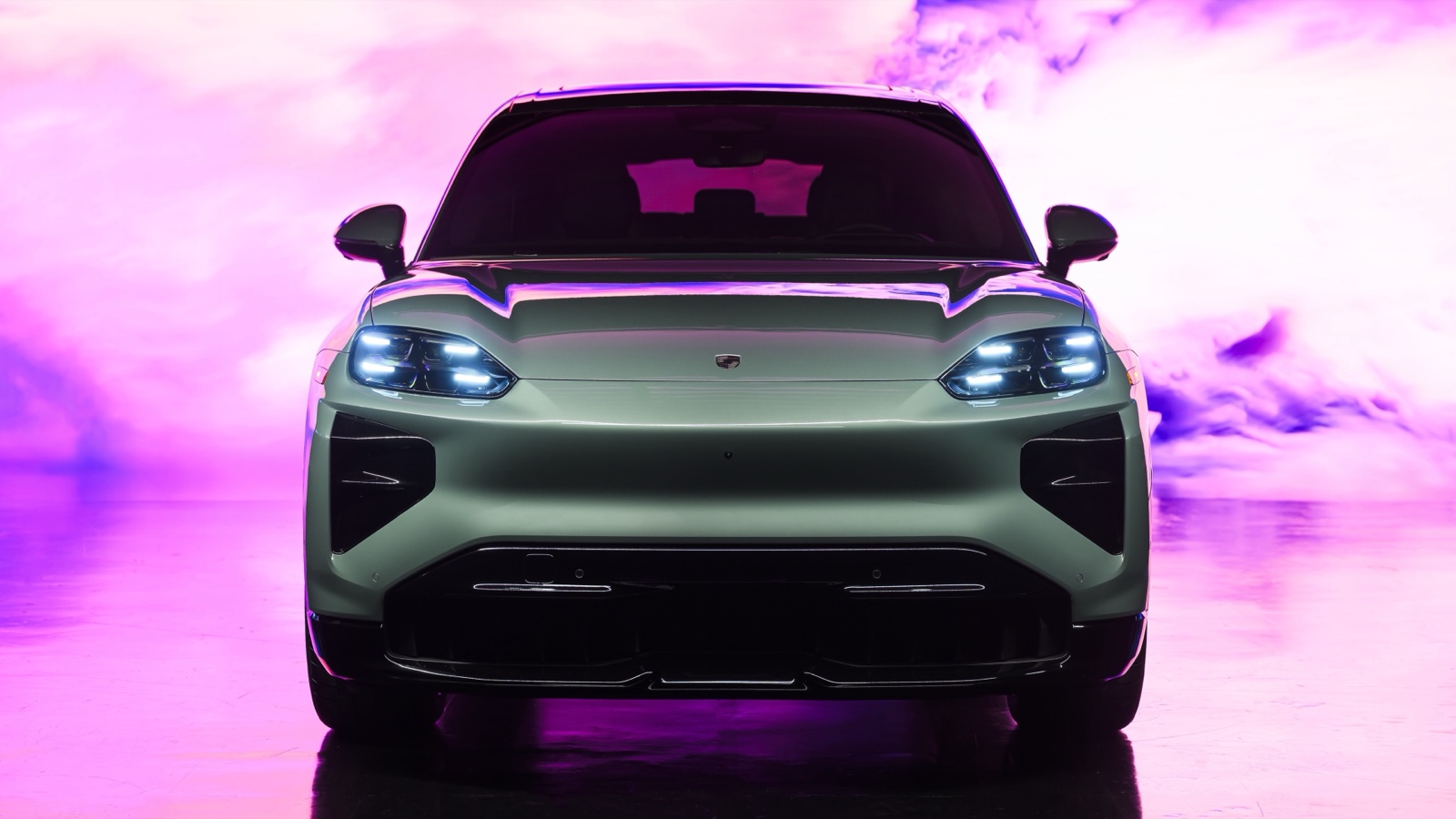 Green Porsche Cayenne Turbo Electric studio shot, front view