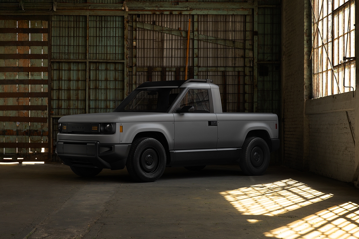 Grey Slate Truck electric pickup in a warehouse, front three-quarter view