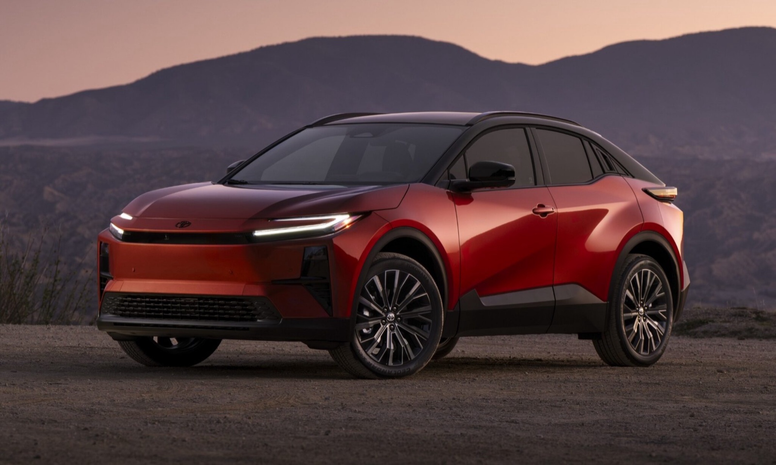 Red and black 2026 Toyota C-HR BEV at dusk in the mountains