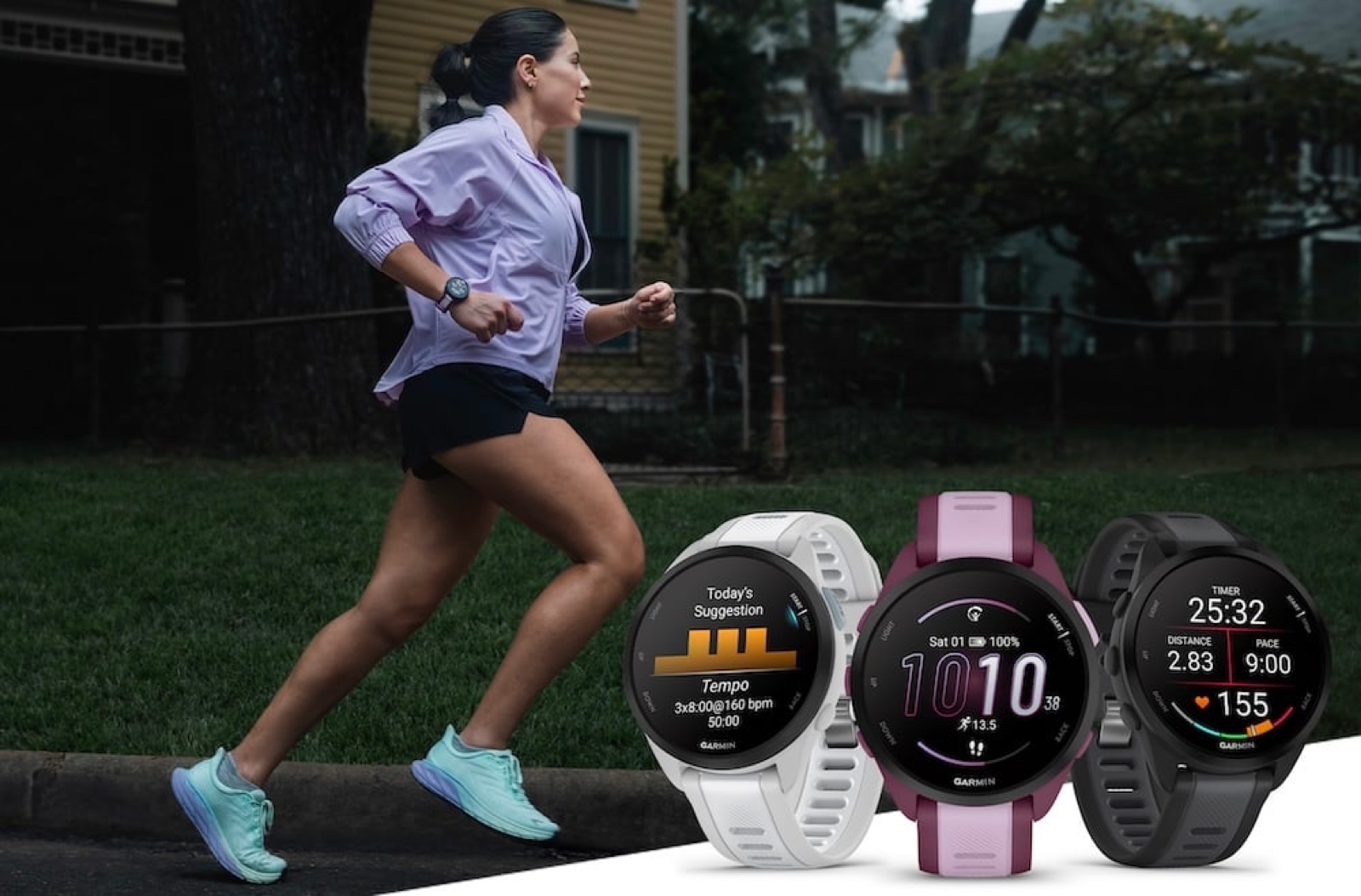 A runner passes three Garmin Forerunner 165 watches in white, berry, and black showing training screens