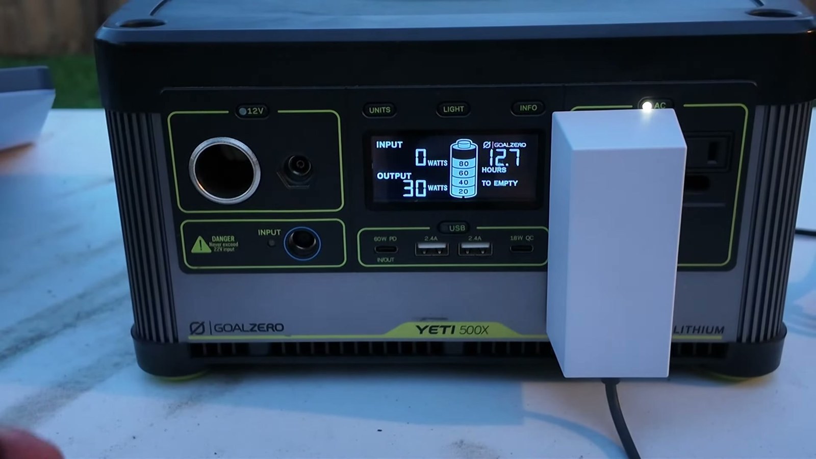 A Goal Zero Yeti 500X power station showing 30 watts of output and 12.7 hours to empty while running a Starlink Mini through its AC brick