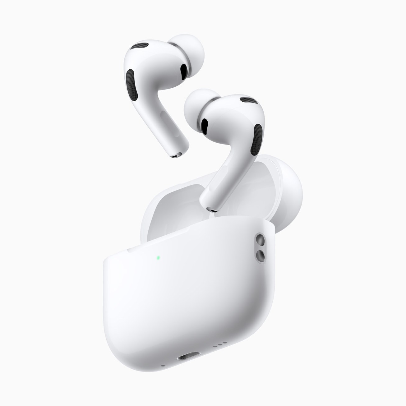 White AirPods Pro 3 earbuds with silicone ear tips floating above their open charging case